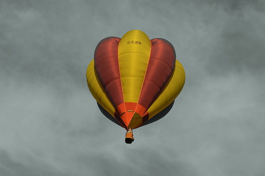 Heart-Shaped Hot Air Balloon Flying in Cloudy Sky