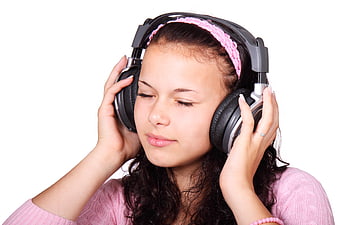 Young woman listening to music with headphones on white background