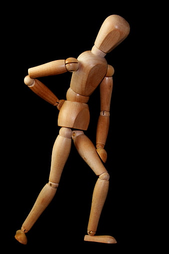 Wooden Mannequin Holding Back in Pain on Black Background