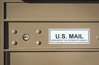 Close-up of U.S. Mailbox with Lock and Official Label