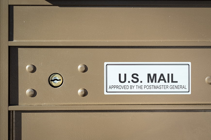 Close-up of U.S. Mailbox with Lock and Official Label