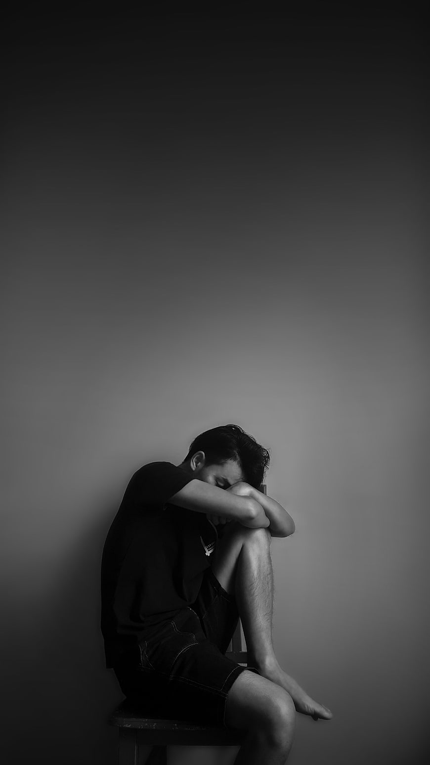 Sad Man Sitting Alone in Black and White