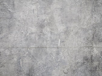 Textured gray concrete wall with cracks and scratches