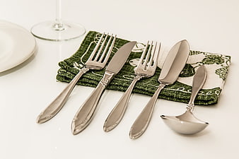 Elegant Silver Cutlery Set On Green Napkin