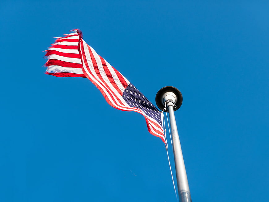 American Flag Waving Against Clear Blue Sky