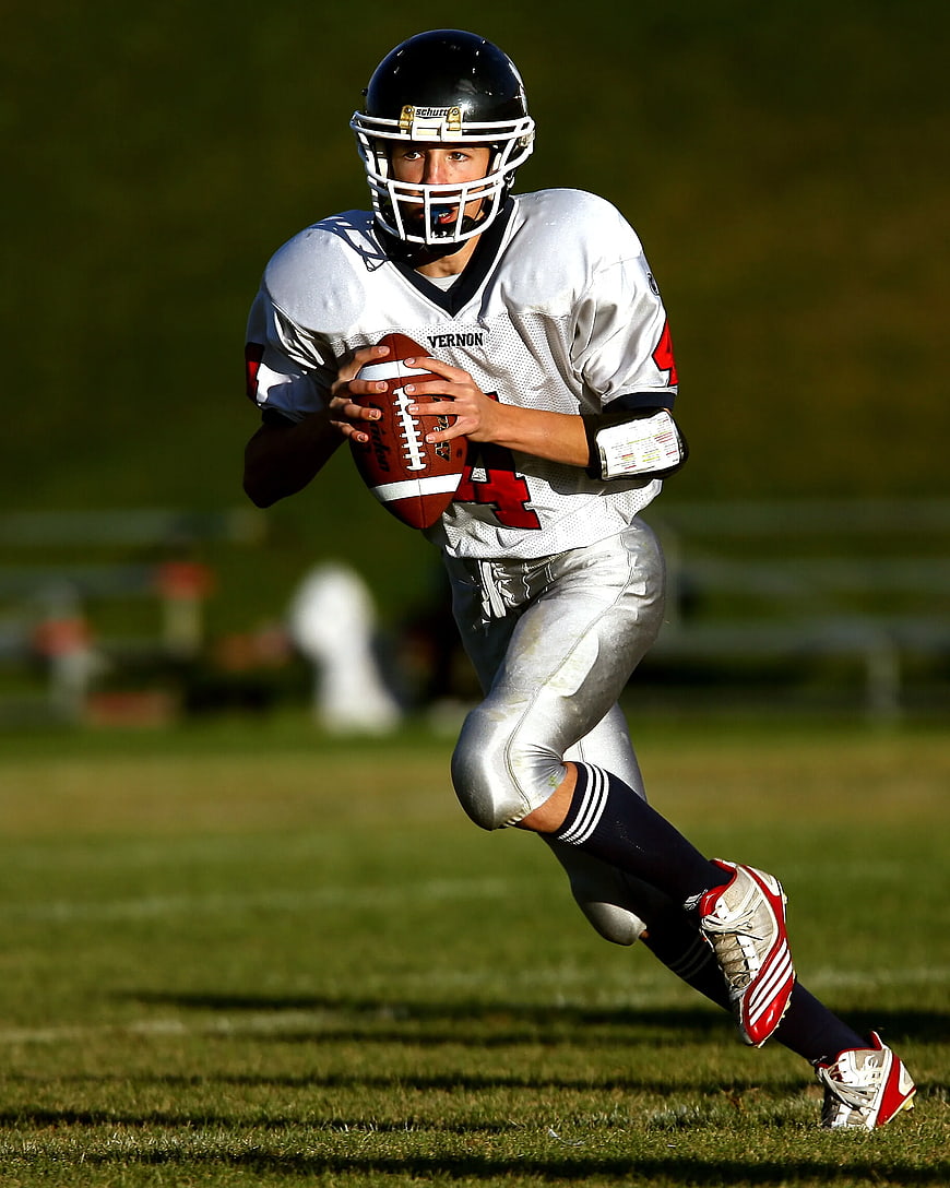 American Football Player Running with Ball on Field