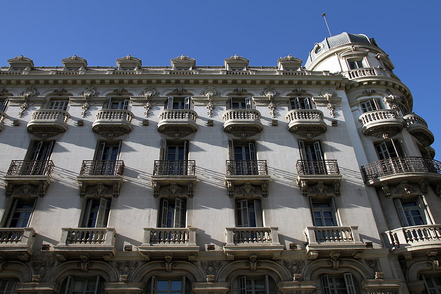 Low angle view of ornate white building facade with balconies
