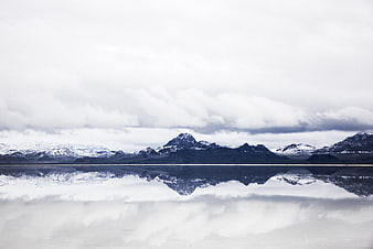 Serene Snow-Capped Mountains Reflected in Calm Water