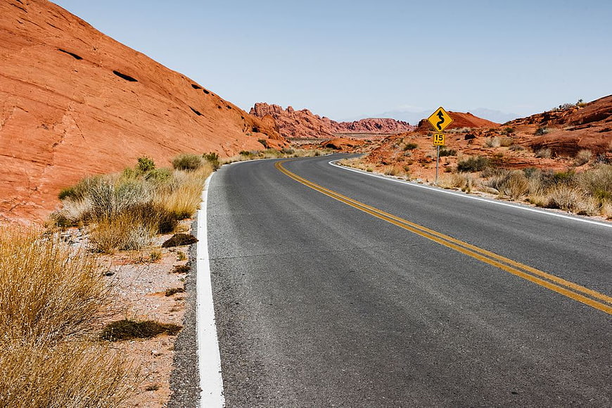 Winding Desert Highway Through Red Rock Canyon Landscape