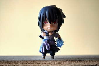 Sasuke Uchiha Nendoroid Figurine on Wooden Surface