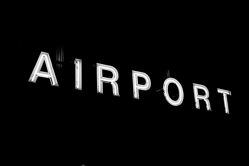 Illuminated Airport Sign at Night