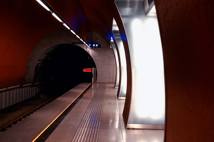 Modern subway station platform with curved illuminated walls