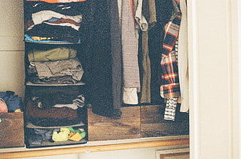 Organized closet interior with hanging shirts and folded clothes