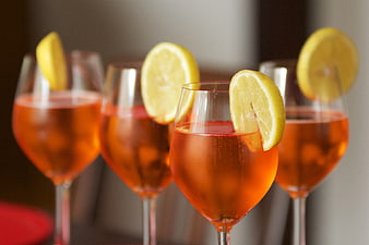 Aperol Spritz cocktails with lemon garnish in wine glasses