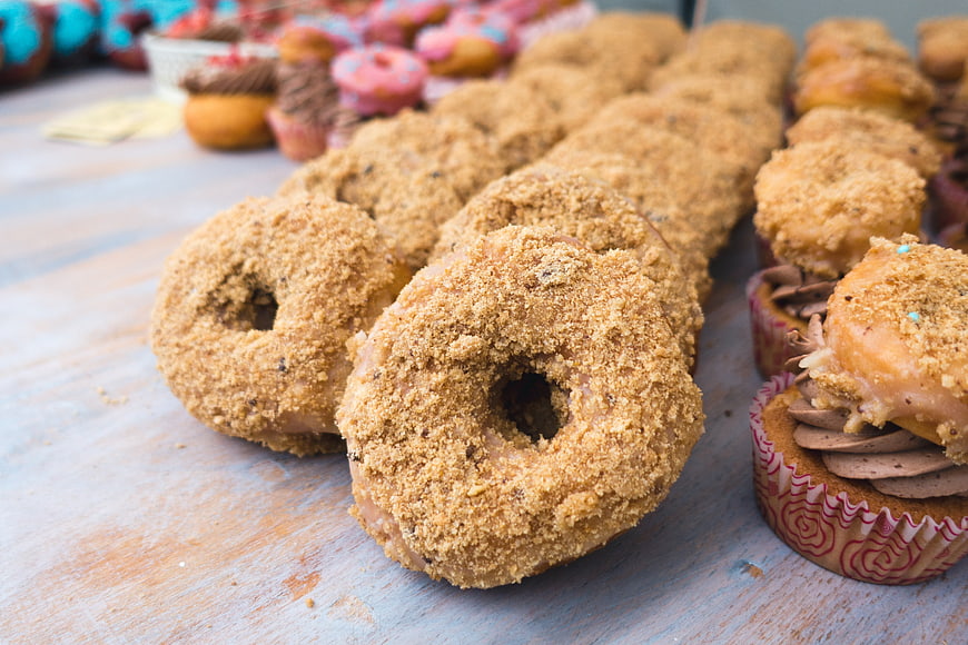 Glazed Donuts with Gritty Sugar Coating on Wooden Table