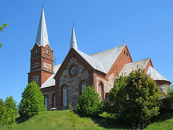 Red Brick Church with Twin Spires on Grassy Hill