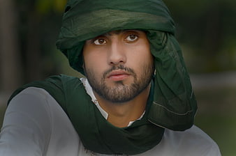 Portrait of man in traditional green headscarf