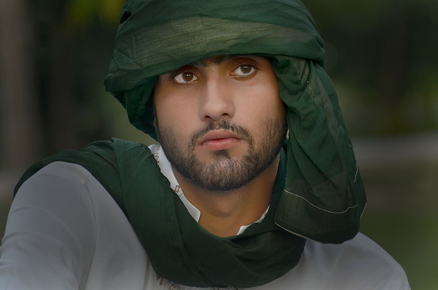 Portrait of man in traditional green headscarf