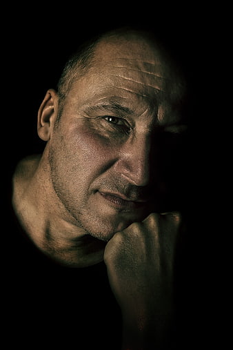 Dramatic chiaroscuro portrait of a contemplative man