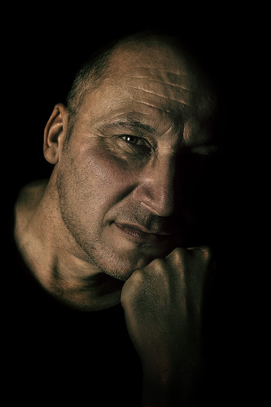 Dramatic chiaroscuro portrait of a contemplative man