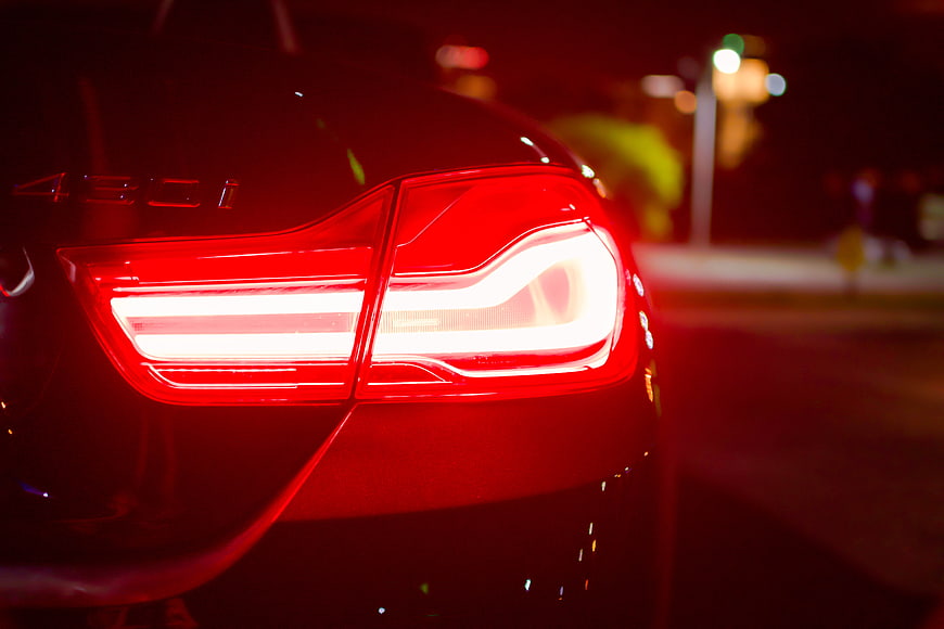 Close-up of glowing red car taillight at night
