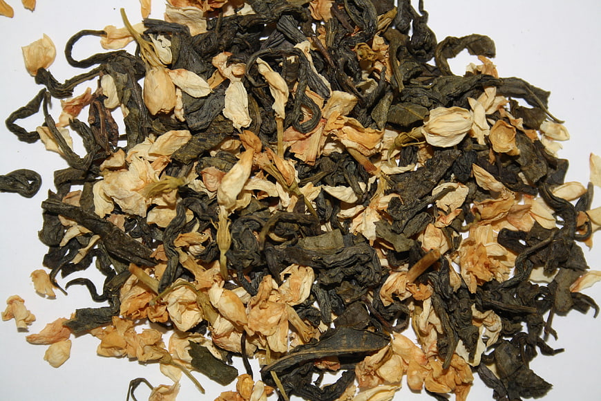 Dried Jasmine Tea Leaves and Flowers on White Background