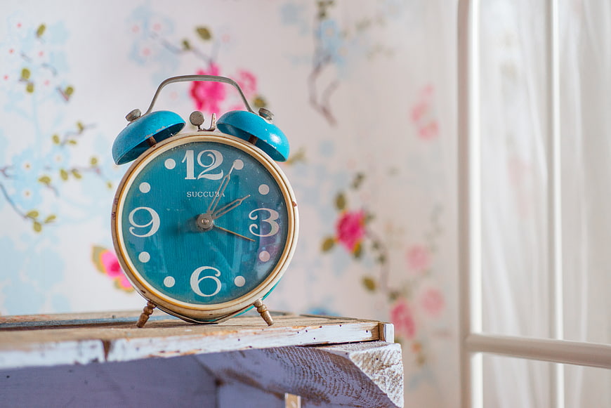 Vintage Blue Alarm Clock on Wooden Shelf