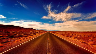 Straight Desert Highway Stretching to Horizon Under Blue Sky