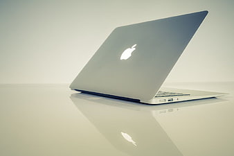 Minimalist Silver Laptop on Reflective White Surface