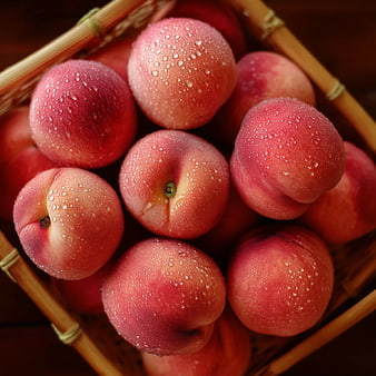 Fresh Ripe Peaches with Water Droplets in Wicker Basket