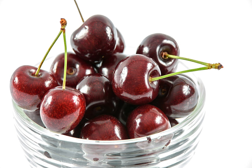 Fresh Red Cherries in Clear Glass Bowl on White Background