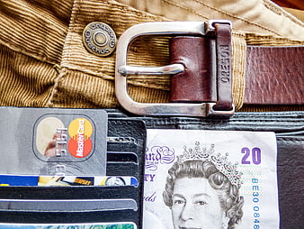 British Pound and Credit Cards in Wallet with Belt