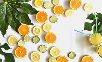 Fresh citrus fruit slices and juice flat lay on white marble