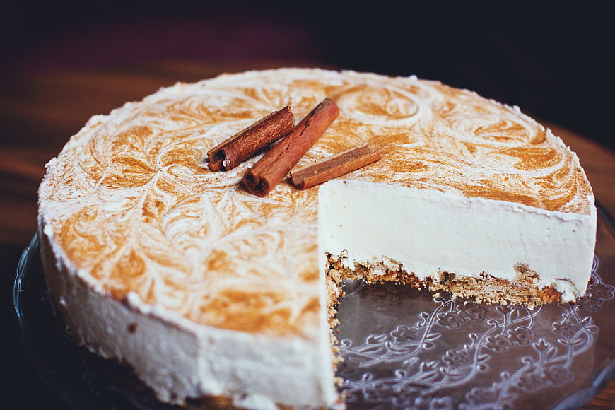 Homemade cinnamon cheesecake with powdered sugar swirls