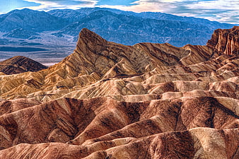 Colorful Zabriskie Point Badlands Landscape with Blue Mountains