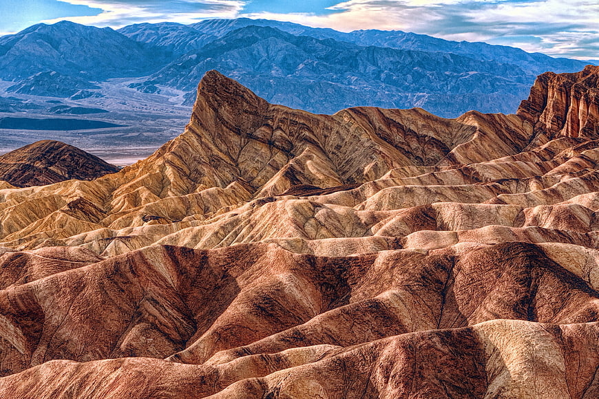 Colorful Zabriskie Point Badlands Landscape with Blue Mountains