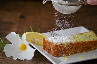 Lemon Cake Slice with Powdered Sugar and Flower