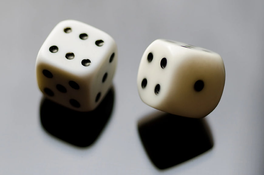 Two White Dice Showing Seven on Gray Background
