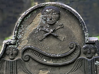 Weathered Old Gravestone with Skull and Crossbones