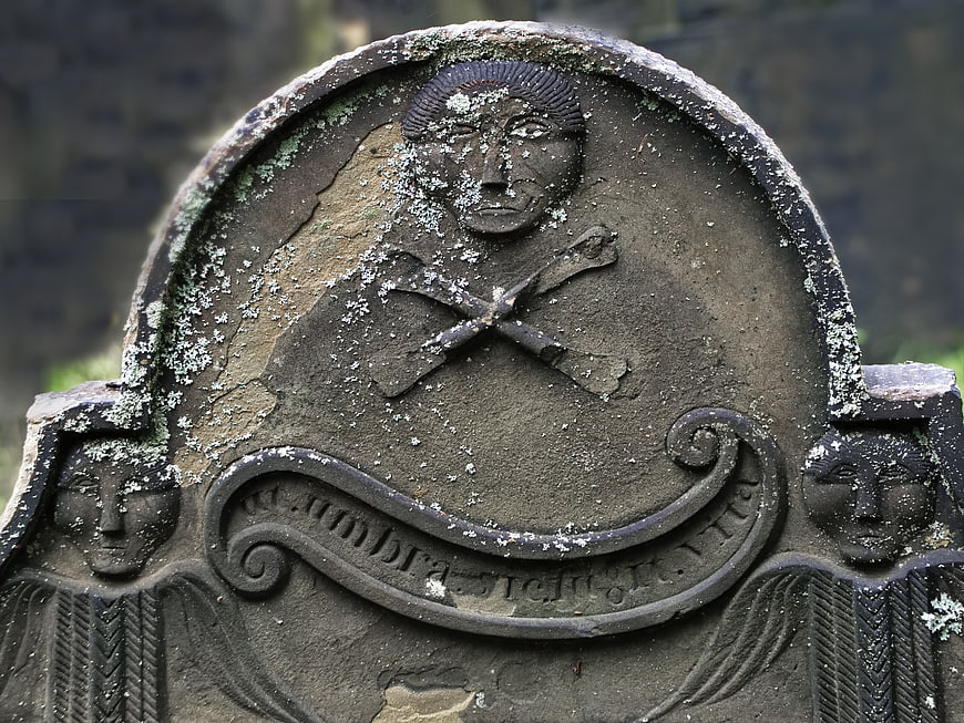 Weathered Old Gravestone with Skull and Crossbones