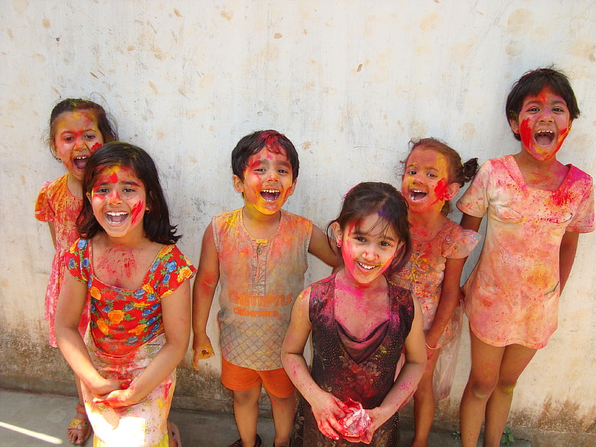 Happy Indian Children Celebrating Holi Festival with Colorful Powder