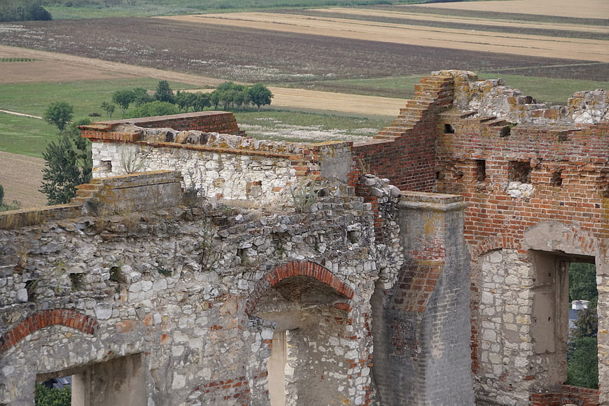 Ruins of an old stone and brick building overlooking fields