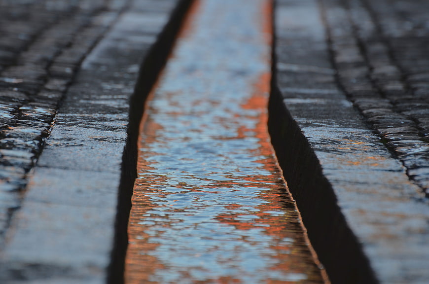 Abstract Close-Up of Wet Wood Planks with Orange Reflection