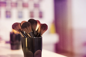 Makeup Brushes In Black Holder With Blurred Beauty Store Background
