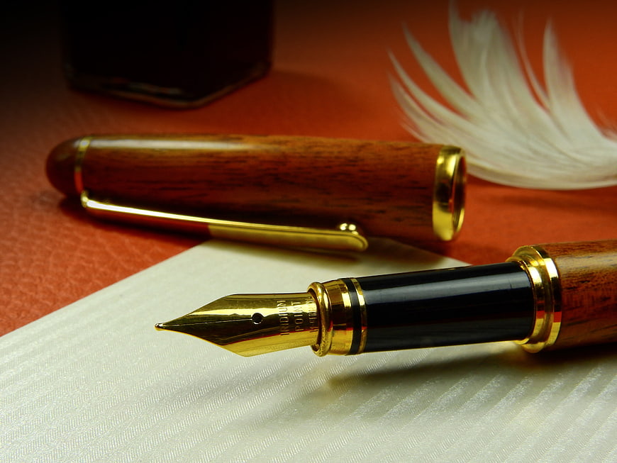 Luxury Wooden Fountain Pen With Gold Nib On White Paper