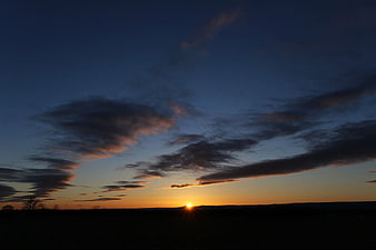 Sunset Silhouette Landscape with Dramatic Clouds
