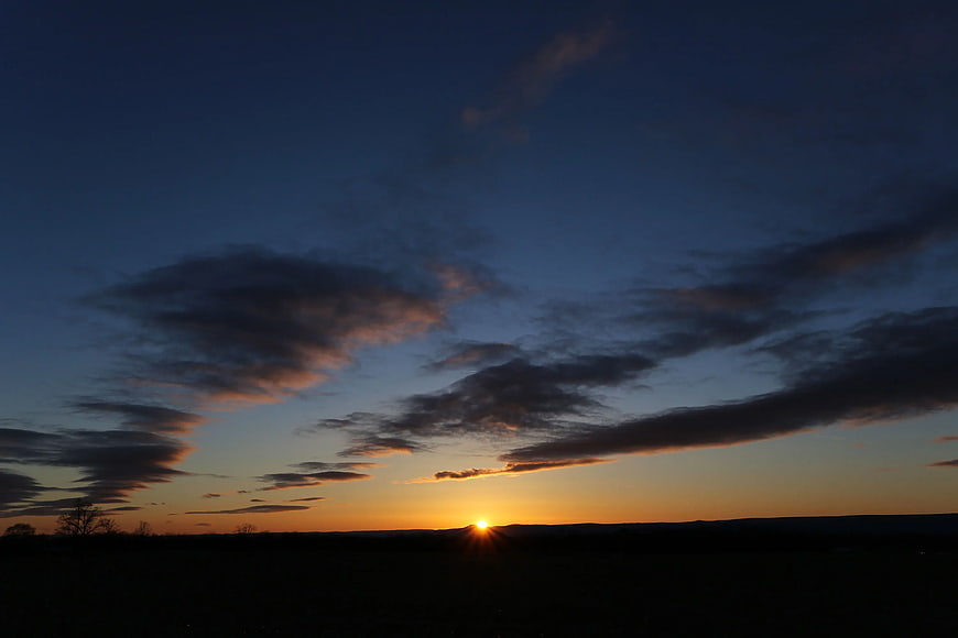 Sunset Silhouette Landscape with Dramatic Clouds