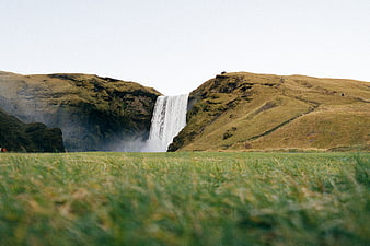 Scenic Skogafoss Waterfall in Iceland with Green Hills
