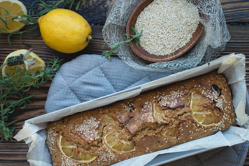 Top View of Fresh Lemon Cake with Sesame Seeds and Herbs