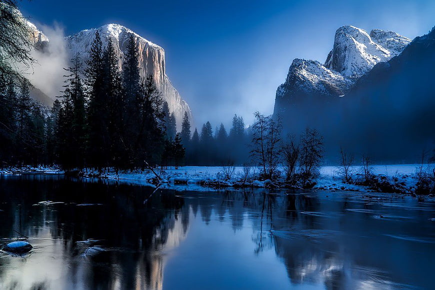 Snowy Winter River Landscape with Majestic Mountains
